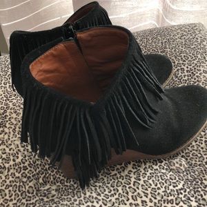 Women’s suede fringe booties.